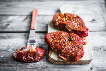 Raw meat on wooden background