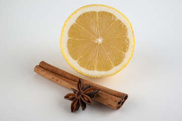 cinnamon, star anise and lemon on white background