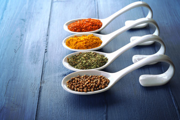Different kinds of spices in ceramics spoons, close-up,