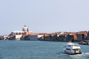 Fototapeta premium Civil passenger boat at the channel in summer Venice