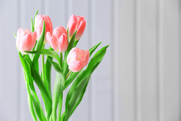 Beautiful pink tulips on wooden background