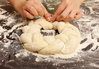 Making pie by female hands on wooden table background