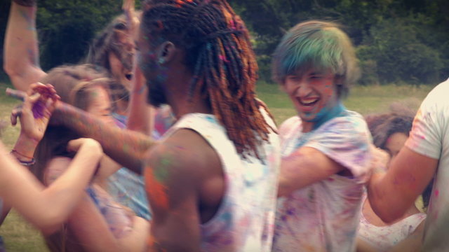 In high quality format happy friends throwing powder paint