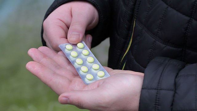 Man with pill package