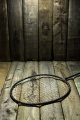 old badminton racket on wood table background