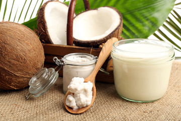 Coconut with jars of coconut oil and  milk