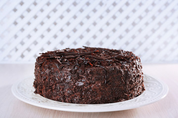 Tasty chocolate cake on table on light background