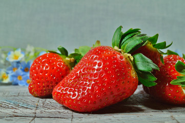 Fresh strawberries on old wooden board