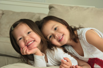 Smiling asian toddler sisters