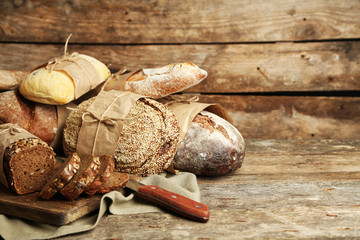 Different fresh bread, on old wooden table
