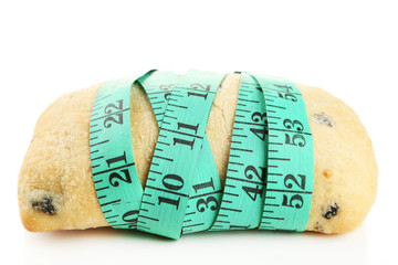 Fresh bread with measuring tape, isolated