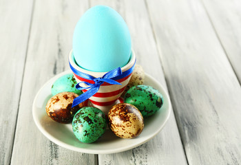 Easter egg in holder on wooden background