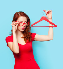 Surprised redhead girl with hanger