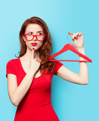 Surprised redhead girl with hanger