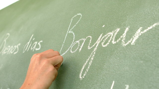 In slow motion french word written on green board