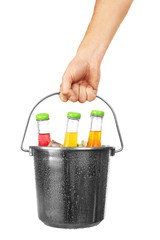 Female hand with metal bucket of alcoholic cocktails isolated