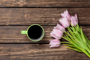 Cup of coffee and bouquet of tulips
