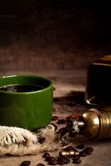 Coffee cup and beans on wooden board