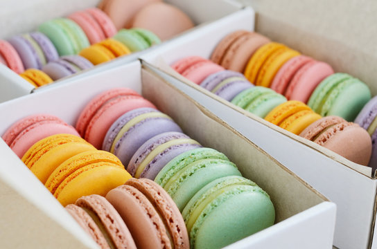 Colorful macarons in white boxes