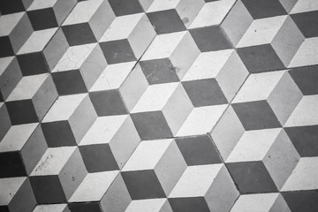 Old black and white tiling on floor, cubic pattern