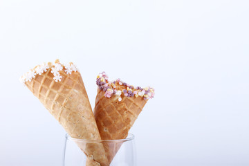 empty ice cream cones with colourful sprinkles
