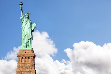 Fototapeta premium Statue of Liberty against blue sky and dramatic clouds