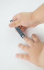 Little hand cutting his fingernail