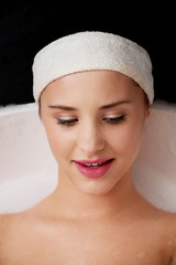 Bathing woman relaxing in bath.