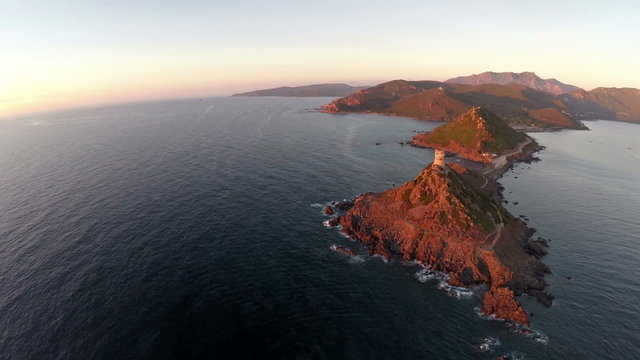 Flight over the sea and islands at sunset, Corsica. Aerial view.