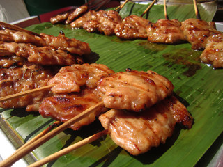 roasted pork on bamboo sticks
