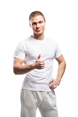 Obraz premium Strong and fit man in white sporty clothes holding thumbs up
