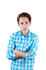 Angry teenager looking in front of his eyes with his arms folded