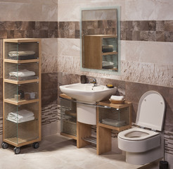 detail of a modern bathroom with sink, cabinet for towels and to