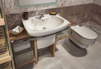 Fototapeta premium detail of a modern bathroom with sink, toilet and cabinet