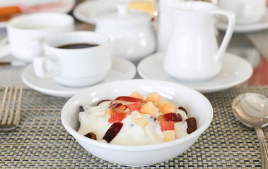 Bowl with fresh fruits salad and yoghurt