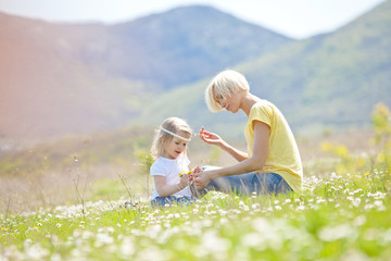 Fototapeta premium Happy woman with a child resting on the nature