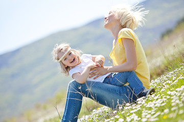 Happy woman with a child resting on the nature