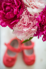 bouquet of spring flowers and children's shoes