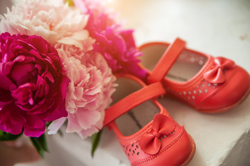 bouquet of spring flowers and children's shoes