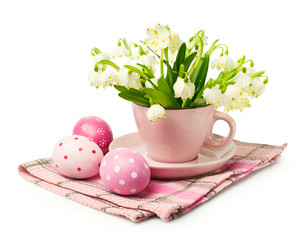 Bouquet of snowdrops in a pink cup and Easter eggs