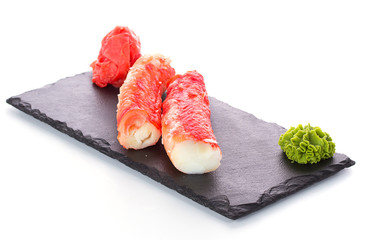 Crab sticks on stone plate isolated on white background