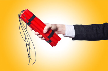 Hand holding bars of dynamite on white