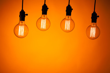 multitude of bulb lamps on orange background