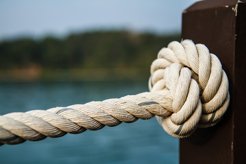 Fototapeta na wymiar White rope tied into a knot.