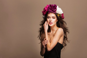sexy model with curle hair and bright flowers on her head