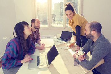 Young group of people discussing business plans.
