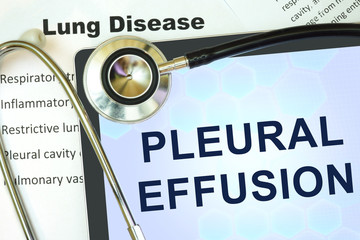 Tablet with words  pleural effusion and stethoscope.