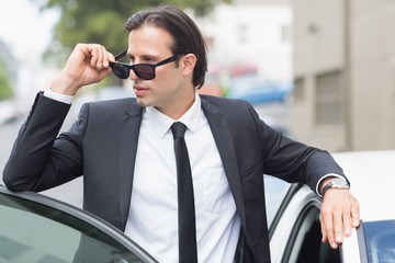 Businessman leaning on the door