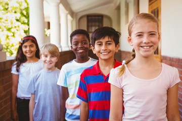 Smiling little school kids in school corridor