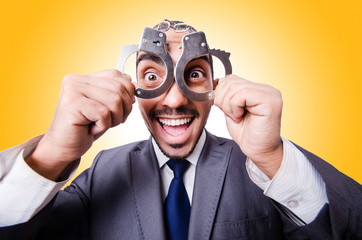 Funny businessman with handcuffs on white